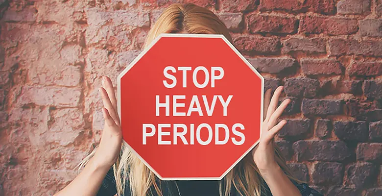 Women holding a sign STOP HEAVY PERIODS